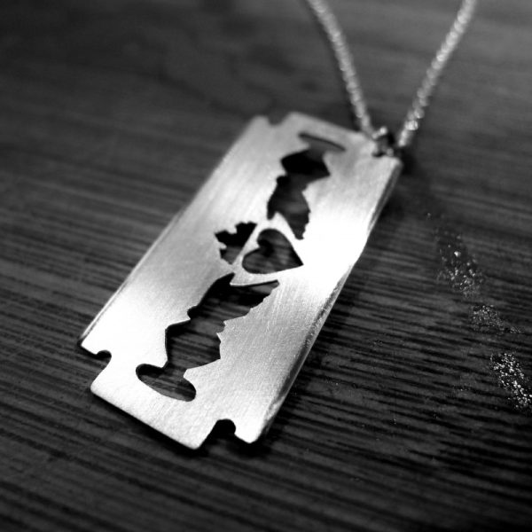 Claddagh Pendant in the shape of a razor. Claddagh necklace in silver.