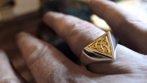 Handcrafted Irish Jewellery Design | Irish Jewellery| Silver Celtic ring with a triangle panel of Irish gold Photograph of a Handcrafted Irish gold and silver Celtic ring.